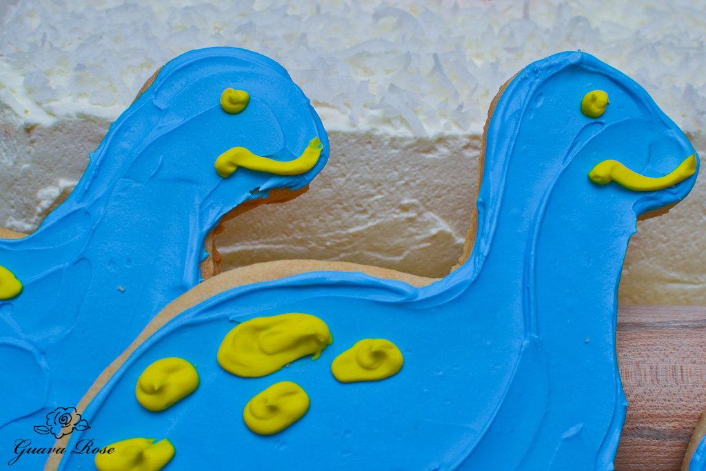 Blue dinosaur cookies up close to haupia chiffon torte