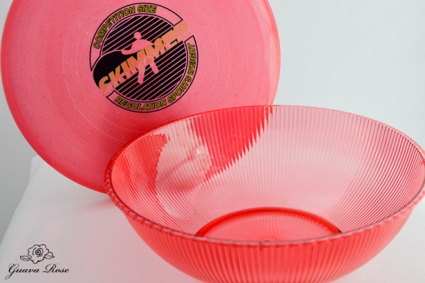 Red frisbee and plastic bowl for Chinese candy holder