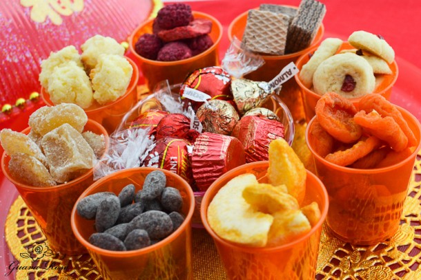 Chinese candy holder, with orange cups filled, top-side view