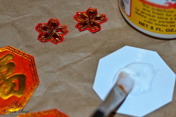 Gluing decorations on chinese candy holder