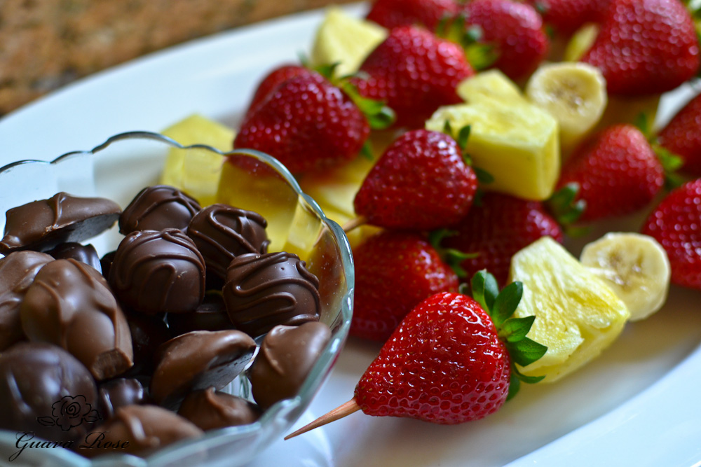 Fruit skewers and chocolate covered macadamia nuts