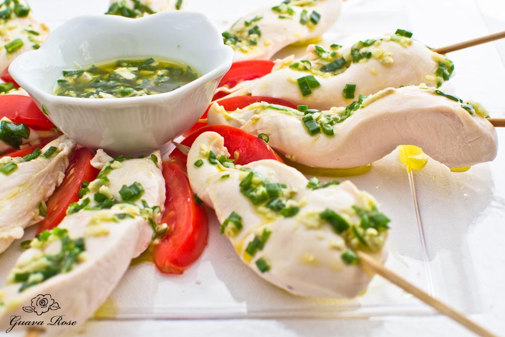 Cold poached chicken tenderloins w/ginger and green onion sauce, close up