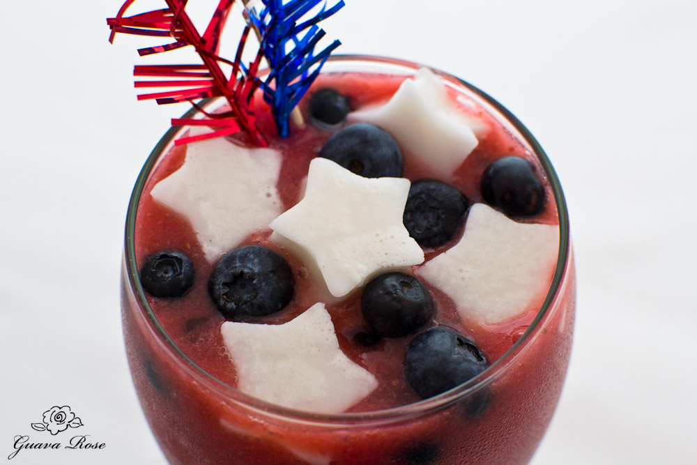 Strawberry Watermelon Smoothie with Blueberries and Haupia Jello Stars, with red/silver/blue frilly picks